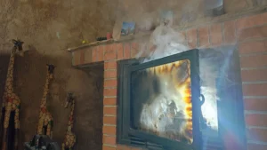 Chimenea revocando humo por obstrucción de hollín